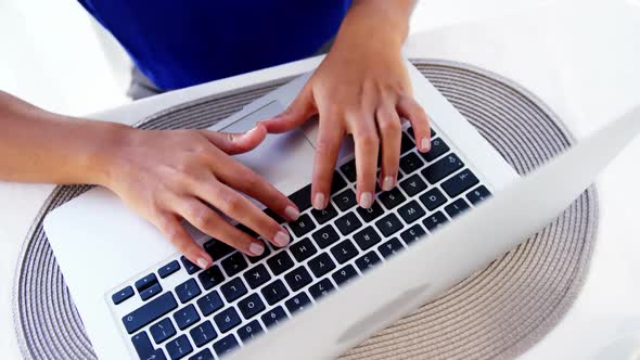 Woman typing on laptop in office