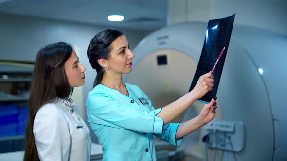 Female specialists analyze the x-ray photo