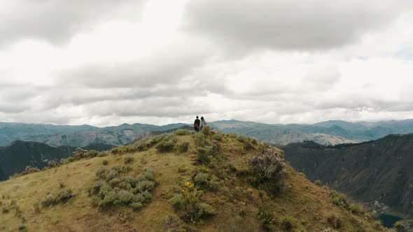 People On The Summit Of Quilotoa Loop Revealing Volcano Lake In Ecuador. Aerial Tilt-up