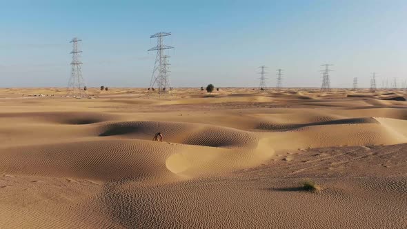 Rub Al Khali Desert and a Young Woman in Yoga Bridge Pose Walking on Sand