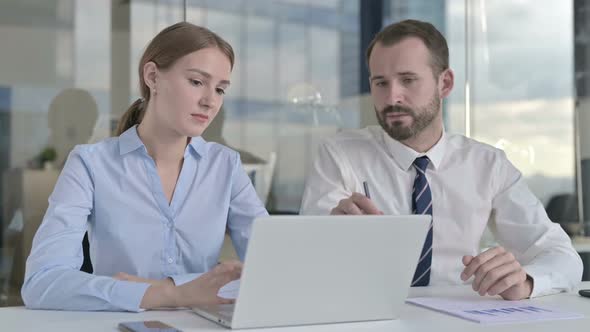 Executive Business People Discussing on Laptop Screen in Office