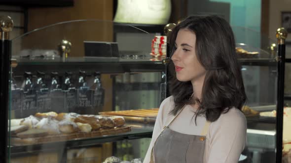 Charming Female Baker Smiling To the Camera at Her Bakery Store