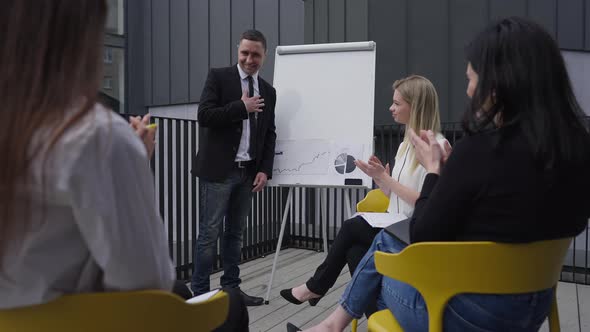 Satisfied Successful Caucasian Man Smiling As Colleagues Clapping Approving Strategy Idea