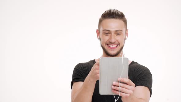 Portrait of Young Handsome Man Speaking on Tablet