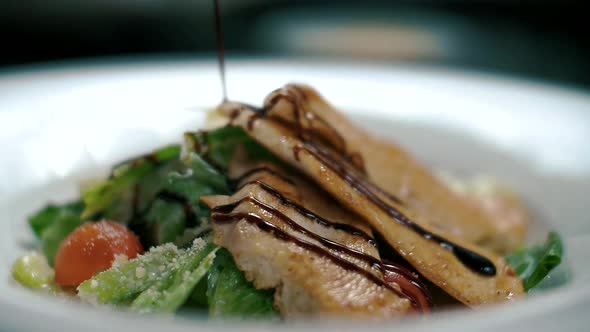 Juicy Caesar salad poured over balsamic vinegar