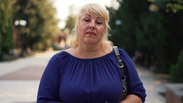 Overweight Woman Walking the City Street