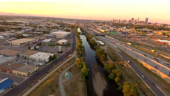 We capture I-25 commuters as well as the Platte River as sunset falls on the Denver Skyline