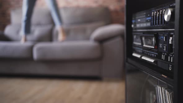 woman dancing on a couch in her house