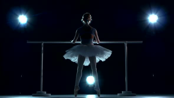 Ballerina in White Tutu Makes You Lean Forward. Back View