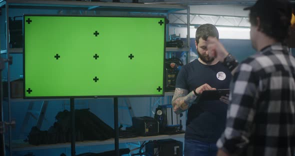 Costumer Checking Video Equipment in Rental Store