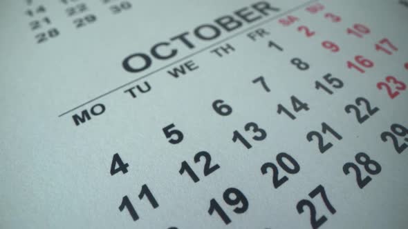 COLUMBUS DAY. Calendar 2021 in Macro Shot. October 12. Girl Mark Date with Red Marker in Calendar