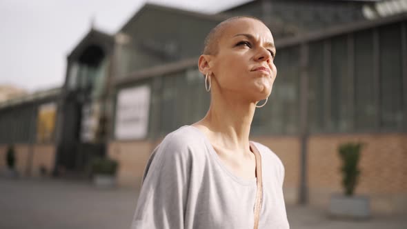 Happy bald woman wearing t-shirt walking