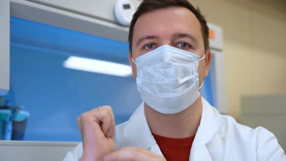 Confident Doctor Man in Mask Talking Look at Camera in Hospital