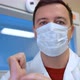 Confident Doctor Man in Mask Talking Look at Camera in Hospital - VideoHive Item for Sale