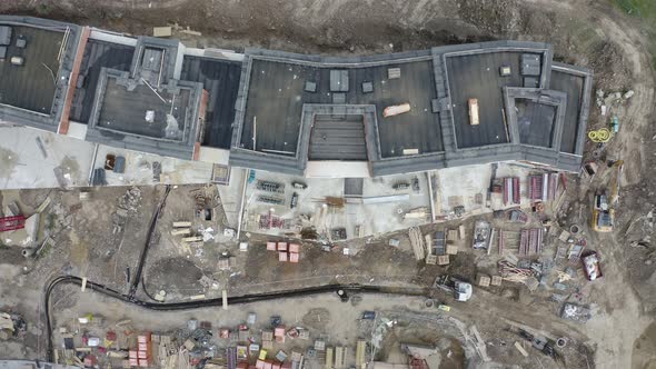 Overhead view of a construction site with unfinished apartment blocks.