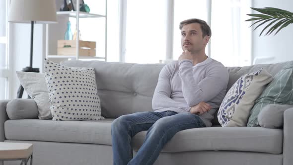 Thinking Pensive Adult Man Sitting Relax on Couch