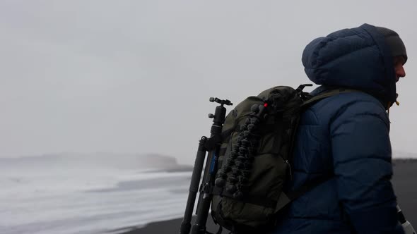 Photographer Running Along Black Sand Beach