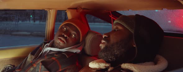 Two Black Men Talking in Car in Evening