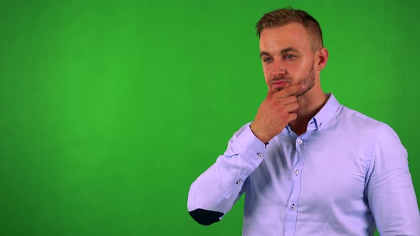 Young Handsome Business Man Thinks About Something - Green Screen - Studio