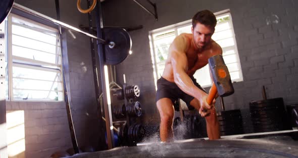 Man doing hammer training exercise