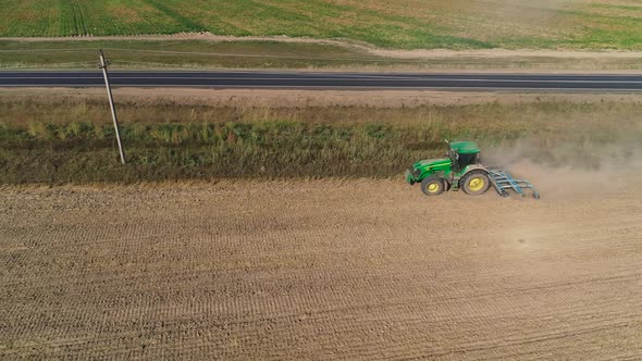 Tractor with Disc Harrows on the Farmland