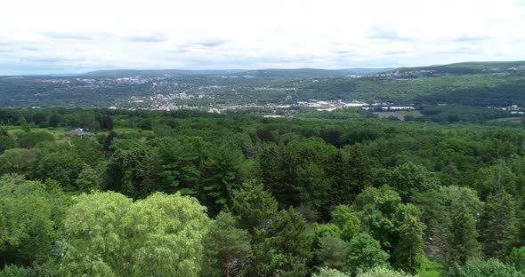 A lazy right dolly of the valley containing Ithaca New York with the college visible in the backgrou