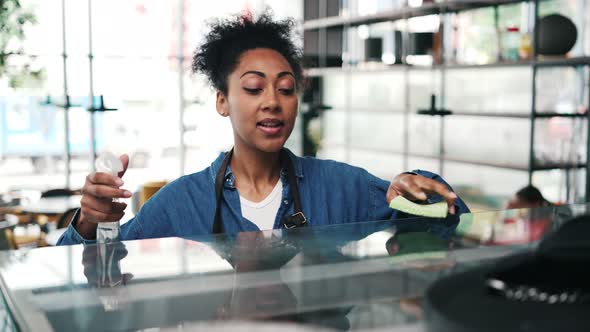 A african american worker woman cleaning the bar counter