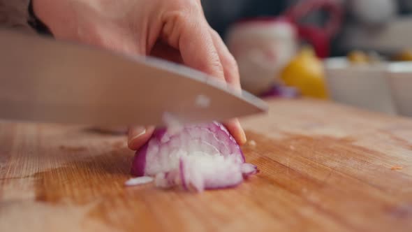 Woman Cuts Onion on a Cutting Board for Cooking Homemade Vegetable Salad