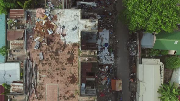Aerial view above of a abandoned housing complex full of trash, Cambodia.