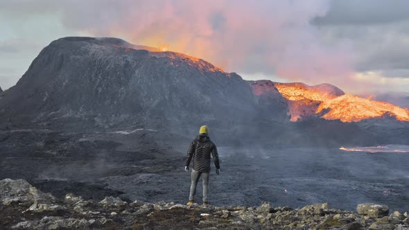 Man Watching Lava Erupting From Fagradalsfjall Volcano In Iceland
