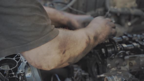 Mechanic Tries to Put Chain on the Pulley