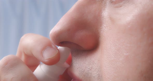 A Person Injects the Medicine Into the Nose Closeup