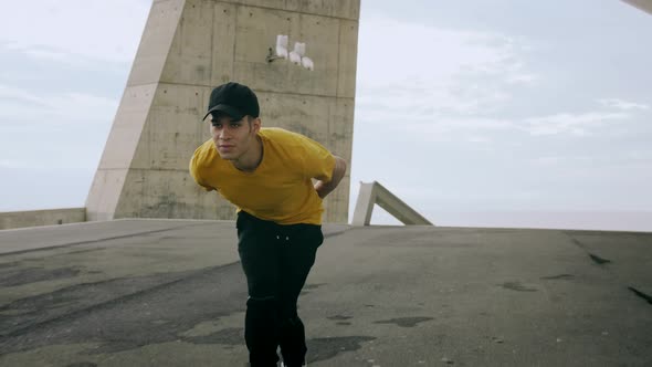 Epic Portrait and close upt of a Young Attractive Trendy Man skateboarding fast under a solar panel