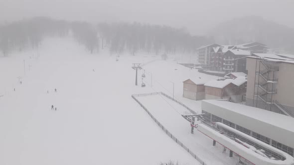 Flying over rope-way with gondolas at mountain resort Crystal Park in Bakuriani. Snowy winter day.