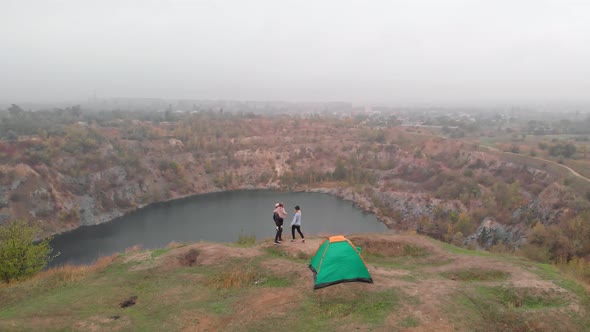 Aerial Drone View of Active Family on Camping Trip Relax Together on Hill Near Lake