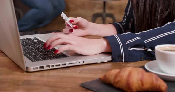 Close Up of the Hands of a Young Woman Making a Payment Using Her Card