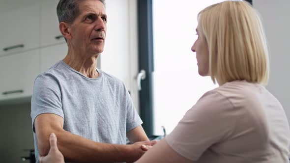 Female physical therapist working with senior man. Shot with RED helium camera in 8K.