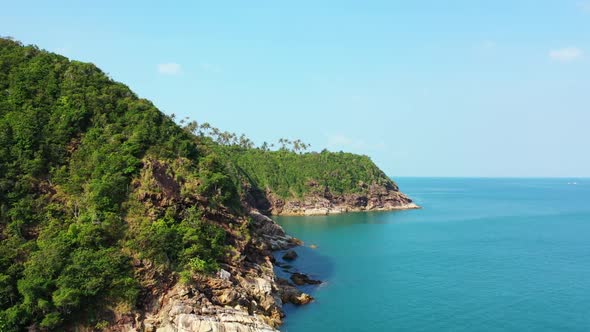 Aerial flying over seascape of luxury island beach trip by blue green ocean with white sandy backgro