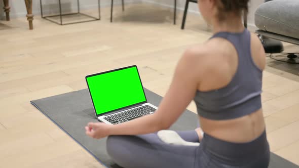 Indian Woman Using Laptop with Chroma Screen on Yoga Mat