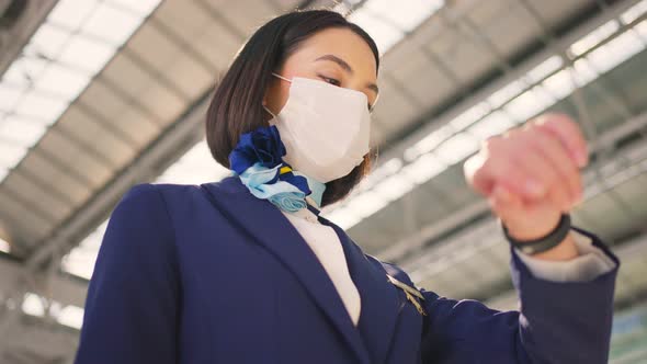 Cabin crew or air hostess wearing face mask, walk in airport terminal to the airplanel during Covid.