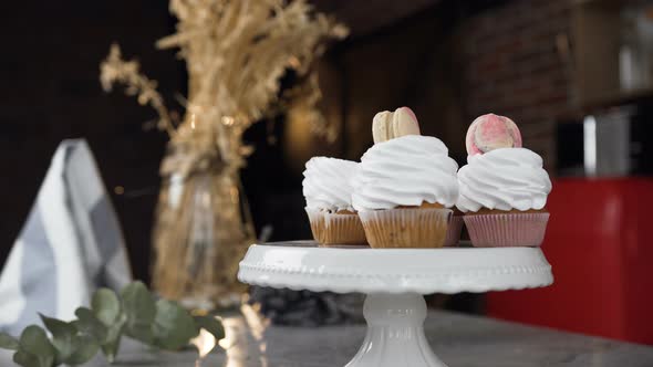 Woman Hands Connecting Two Halves of Macaroons Using Cream