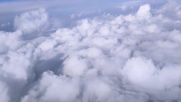 Top View From the Plane to the Sky with Cumulus Clouds in Sunny Weather