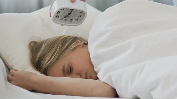 School Girl Ignoring Alarm Clock, Sleeping in Morning and Missing Lessons