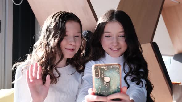 Two fun beautiful sisters take selfie photos