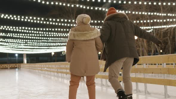 Couple Skating On Ice Rink