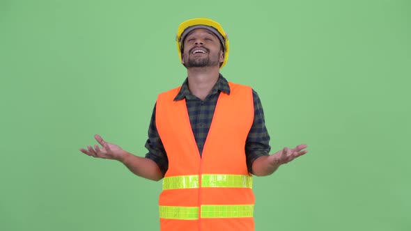 Happy Young Bearded Persian Man Construction Worker Catching Something