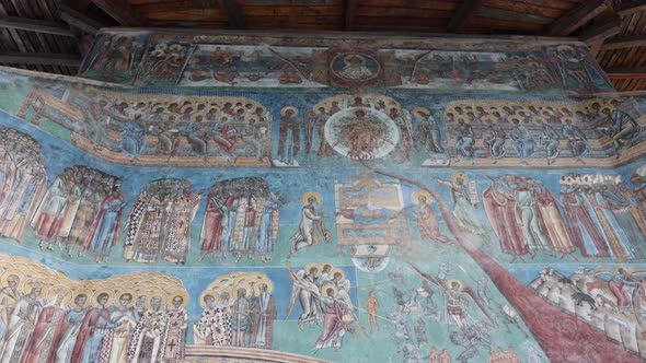 Detail Of Murals In Blue Exterior Walls Of Voronet Monastery In Suceava, Romania