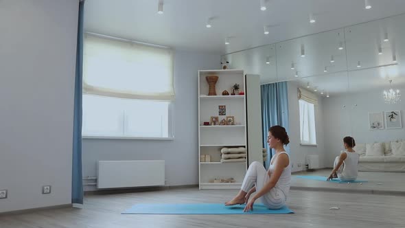 Barefoot Woman Practicing Yoga on Floor