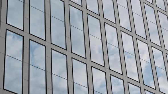 Motion Camera View of the Business District Building with Wall Mirror with Blue Cloudy Sky Reflected