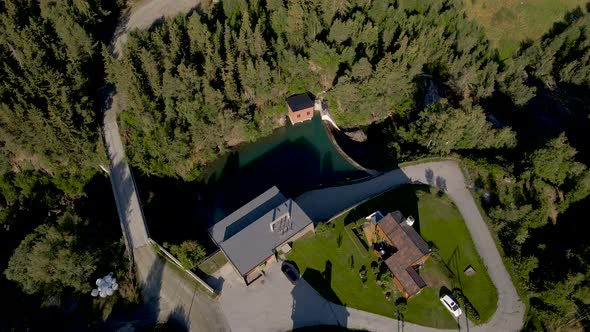 Top View Of Hydro Power Plant With Reservoir And Pine Forest In Norway. aerial